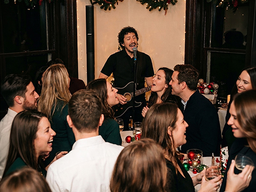 Marcel Acoustic performing at a corporate holiday party