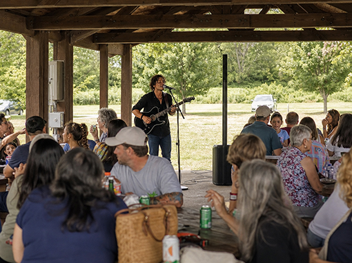Multi-generational family reunion gathering with live music